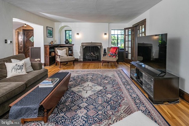 722 River Rd, Ewing, NJ 08628 - living room with a fireplace, wood finished floors, and arched walkways