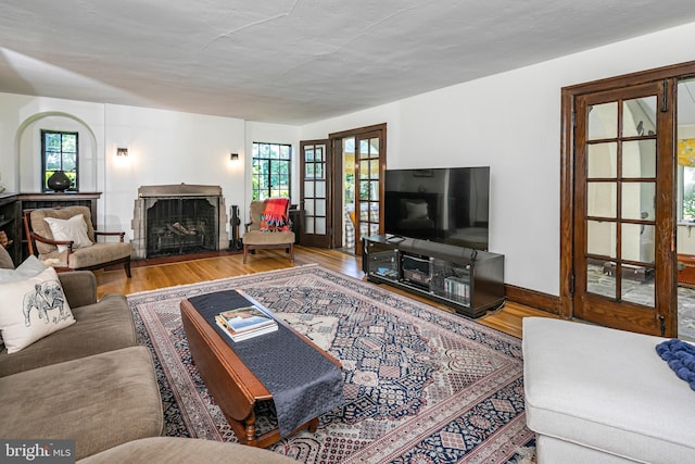 722 River Rd, Ewing, NJ 08628 - living room featuring wood finished floors, healthy amount of natural light, and a fireplace