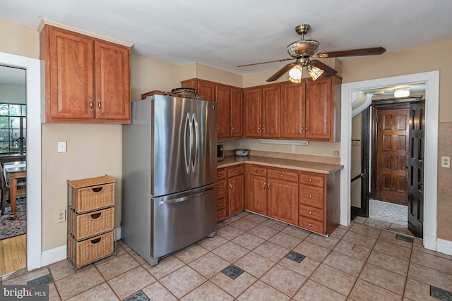 722 River Rd, Ewing, NJ 08628 - kitchen featuring freestanding refrigerator, a ceiling fan, light countertops, and brown cabinetry