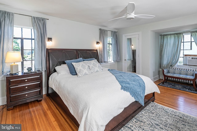 722 River Rd, Ewing, NJ 08628 - bedroom with wood finished floors, a ceiling fan, and cooling unit
