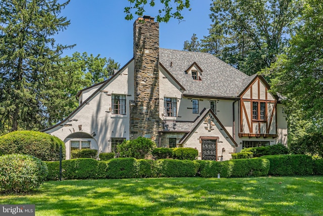 722 River Rd, Ewing, NJ 08628 - tudor-style house with stucco siding, a chimney, and a front lawn