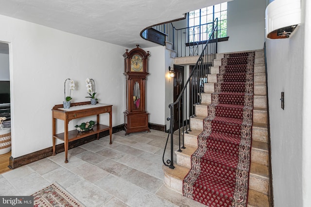 722 River Rd, Ewing, NJ 08628 - stairway with baseboards and stone finish floors