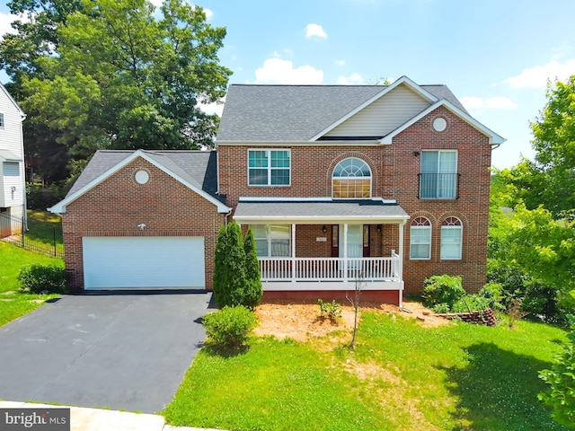 7403 Hawthorne St, Landover, MD 20785 - view of front facade featuring covered porch, brick siding, driveway, and an attached garage