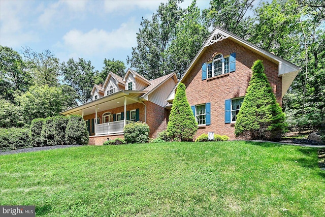 59 Segovia Ct, Hanover, PA 17331 - view of front facade with brick siding, a front yard, and covered porch
