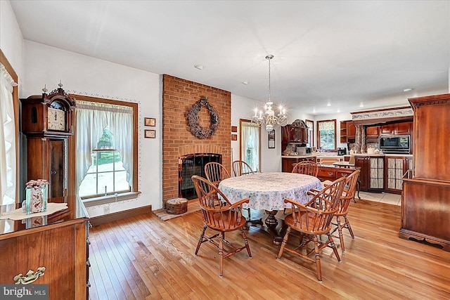 59 Segovia Ct, Hanover, PA 17331 - dining space featuring a fireplace, light wood-style floors, a chandelier, and recessed lighting