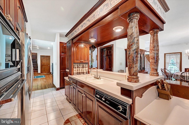 59 Segovia Ct, Hanover, PA 17331 - kitchen featuring ornate columns, light countertops, light tile patterned flooring, and dishwasher