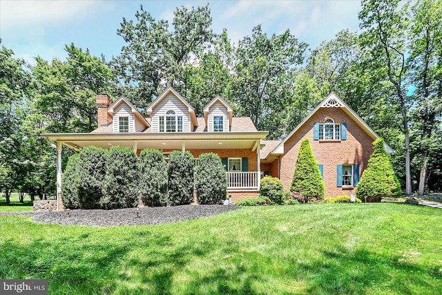 59 Segovia Ct, Hanover, PA 17331 - view of front of house with brick siding, a front lawn, a chimney, and a porch