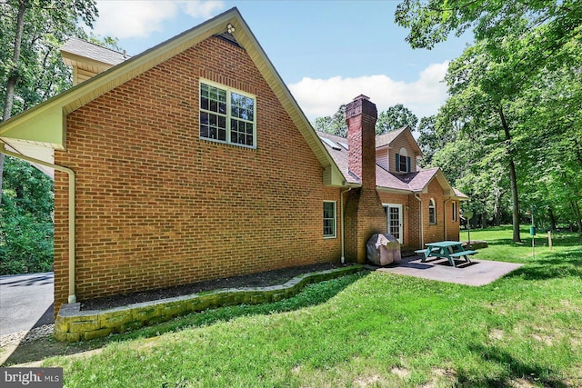 59 Segovia Ct, Hanover, PA 17331 - back of property with brick siding, a patio, a chimney, and a lawn