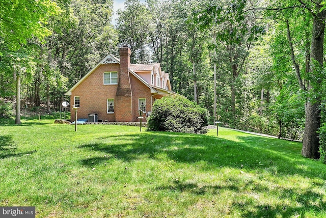 59 Segovia Ct, Hanover, PA 17331 - view of side of home with a yard, a chimney, and brick siding