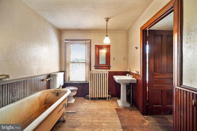 2505-2507 High St, Port Norris, NJ 08349 - bathroom with radiator, wood-type flooring, a wainscoted wall, and a freestanding bath
