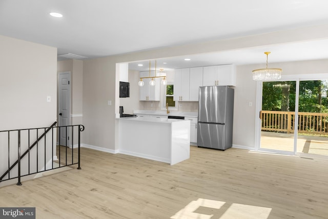 1614 Maryland Ave, Woodbridge, VA 22191 - kitchen with freestanding refrigerator, light wood-type flooring, white cabinets, plenty of natural light, and recessed lighting