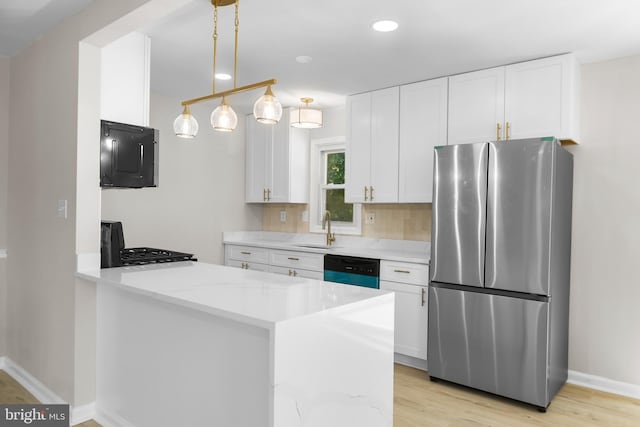 1614 Maryland Ave, Woodbridge, VA 22191 - kitchen featuring freestanding refrigerator, dishwasher, range, white cabinets, and a peninsula