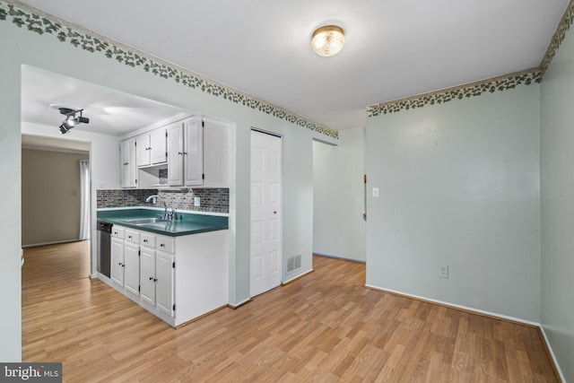 1804 Aberdeen Cir, Crofton, MD 21114 - kitchen with light wood finished floors, decorative backsplash, white cabinetry, dark countertops, and stainless steel dishwasher