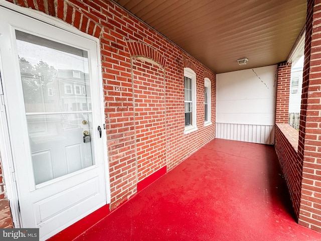 2411 N W St, Wilmington, DE 19802 - view of exterior entry featuring covered porch and brick siding