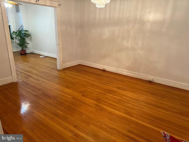 812 Emerson St NW, Washington, DC 20011 - empty room with hardwood / wood-style flooring and a chandelier