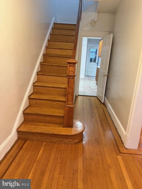 812 Emerson St NW, Washington, DC 20011 - staircase featuring wood-type flooring and baseboards