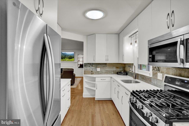 109 Wyomissing Blvd, Wyomissing, PA 19610 - kitchen featuring appliances with stainless steel finishes, open shelves, white cabinets, decorative backsplash, and light countertops