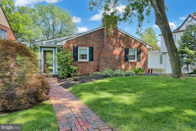 109 Wyomissing Blvd, Wyomissing, PA 19610 - view of front of house featuring brick siding, a chimney, and a front lawn
