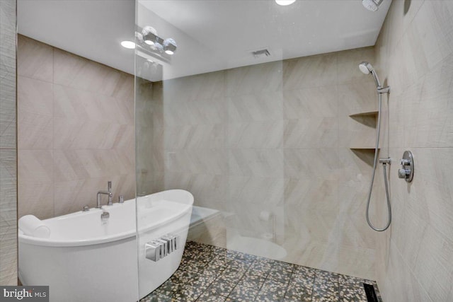 109 Wyomissing Blvd, Wyomissing, PA 19610 - bathroom with a freestanding tub, a walk in shower, tile patterned floors, and tile walls