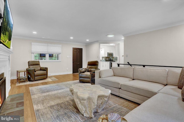 109 Wyomissing Blvd, Wyomissing, PA 19610 - living area featuring a fireplace with flush hearth, light wood finished floors, recessed lighting, and ornamental molding