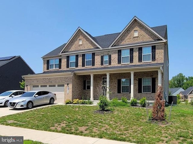 9932 Pesade Way, Upper Marlboro, MD 20772 - view of front of home with brick siding, a front lawn, driveway, and covered porch