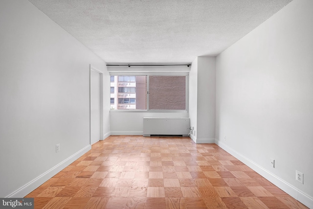 4515 Willard Ave Unit 915S, Chevy Chase, MD 20815 - spare room with a textured ceiling and radiator