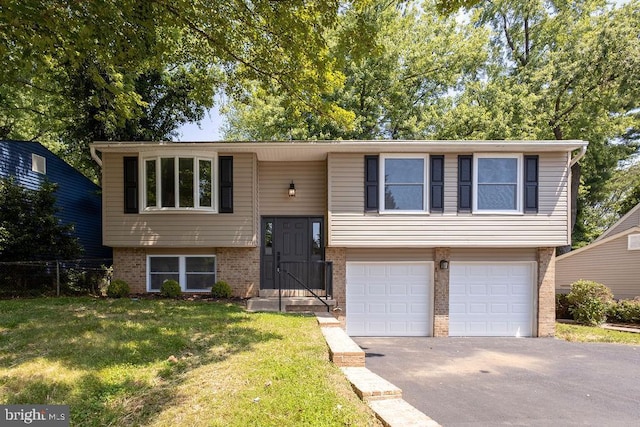 19023 Staleybridge Rd, Germantown, MD 20876 - split foyer home featuring brick siding, an attached garage, and driveway