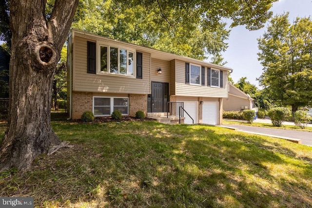 19023 Staleybridge Rd, Germantown, MD 20876 - raised ranch with an attached garage, a front yard, driveway, and brick siding