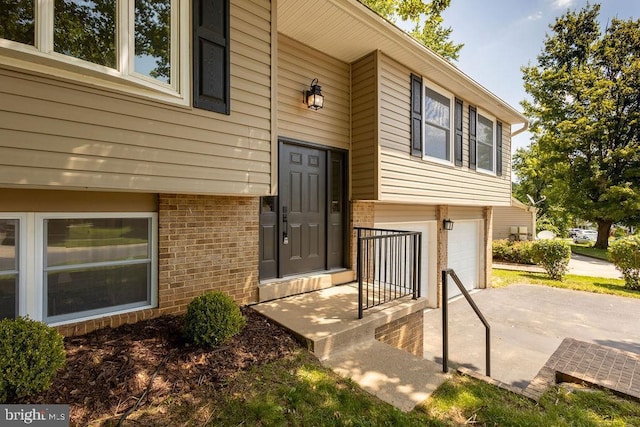 19023 Staleybridge Rd, Germantown, MD 20876 - property entrance with brick siding, a garage, and concrete driveway