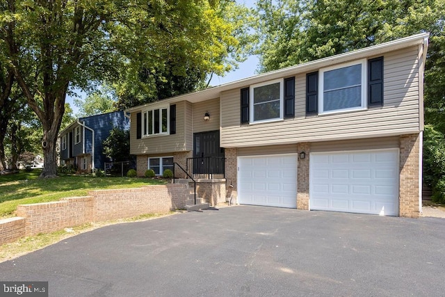 19023 Staleybridge Rd, Germantown, MD 20876 - split foyer home with a garage, driveway, and brick siding