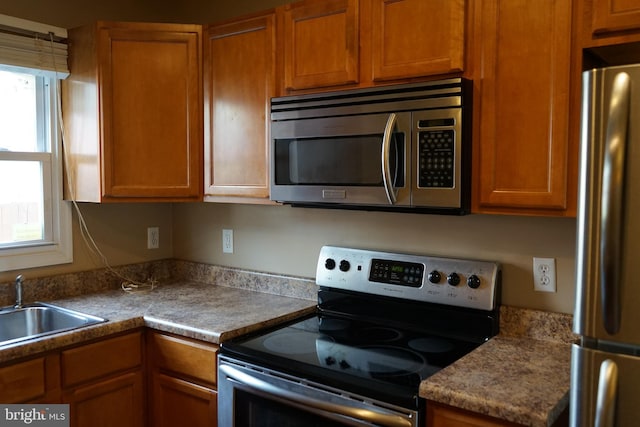 324 W 29th St, Baltimore, MD 21211 - kitchen with appliances with stainless steel finishes, healthy amount of natural light, and brown cabinets