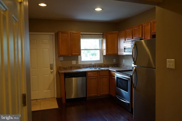 324 W 29th St, Baltimore, MD 21211 - kitchen with appliances with stainless steel finishes, recessed lighting, dark wood finished floors, and brown cabinetry