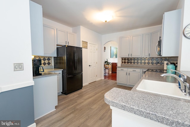 39 Mission Way, Barnegat, NJ 08005 - kitchen with freestanding refrigerator, backsplash, arched walkways, and stainless steel microwave