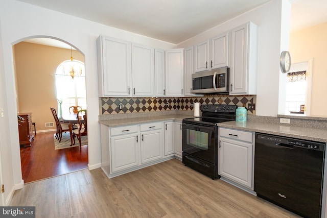 39 Mission Way, Barnegat, NJ 08005 - kitchen featuring black appliances, healthy amount of natural light, light wood-type flooring, and backsplash
