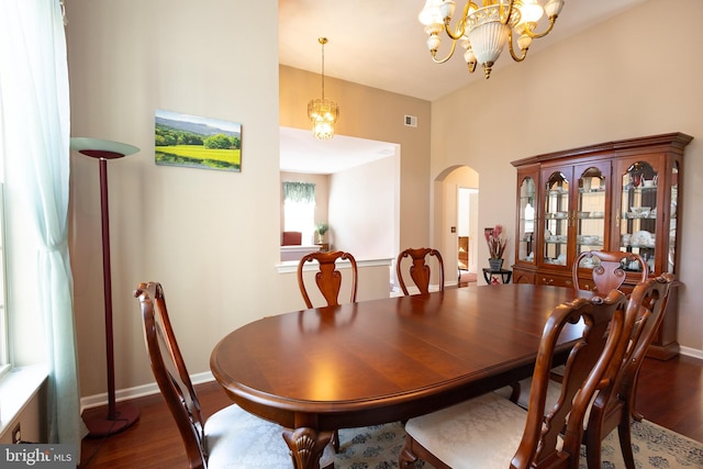 39 Mission Way, Barnegat, NJ 08005 - dining area featuring arched walkways, dark wood-type flooring, a chandelier, and a high ceiling