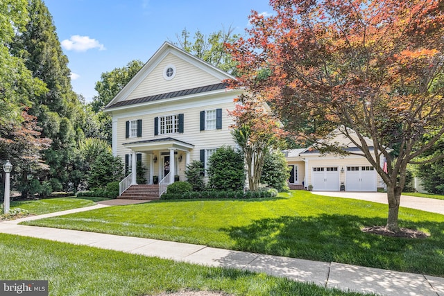 2819 Live Oak Ln, Midlothian, VA 23113 - greek revival house featuring a front yard, driveway, a metal roof, an attached garage, and a standing seam roof