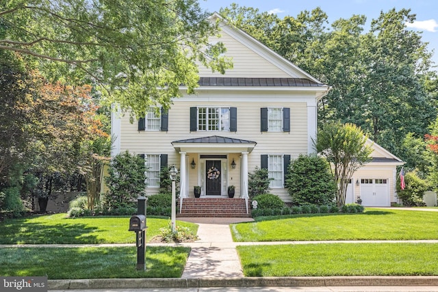 2819 Live Oak Ln, Midlothian, VA 23113 - greek revival house with a standing seam roof, a metal roof, an attached garage, and a front yard