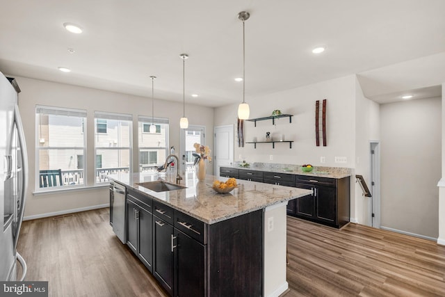 20318 Peacemaker Dr, Germantown, MD 20874 - kitchen with open shelves, wood finished floors, appliances with stainless steel finishes, a kitchen island with sink, and recessed lighting
