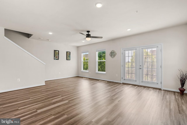 20318 Peacemaker Dr, Germantown, MD 20874 - unfurnished living room with a ceiling fan, french doors, wood finished floors, recessed lighting, and stairway