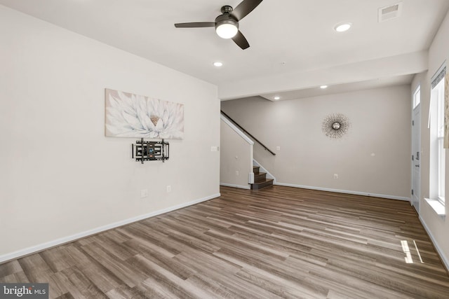 20318 Peacemaker Dr, Germantown, MD 20874 - unfurnished living room with wood finished floors, a ceiling fan, stairs, and recessed lighting