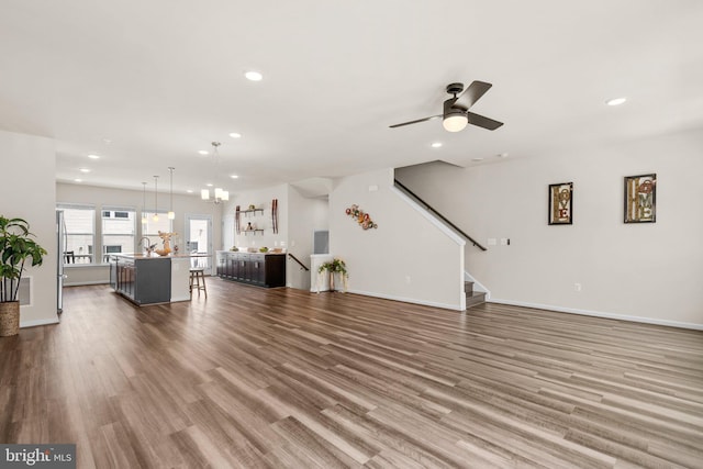 20318 Peacemaker Dr, Germantown, MD 20874 - living room featuring recessed lighting, wood finished floors, ceiling fan, and stairway