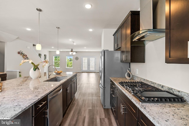 20318 Peacemaker Dr, Germantown, MD 20874 - kitchen with stainless steel appliances, wall chimney range hood, dark wood-style floors, light stone countertops, and dark brown cabinets