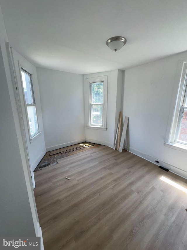 4335 N 15th St, Philadelphia, PA 19140 - empty room featuring healthy amount of natural light and wood finished floors