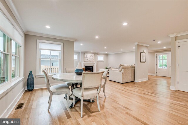 569 Riverside Dr, Princeton, NJ 08540 - dining space with ornamental molding, a glass covered fireplace, recessed lighting, and light wood-style floors