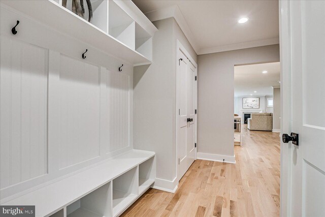 569 Riverside Dr, Princeton, NJ 08540 - mudroom featuring wood finished floors, a fireplace, recessed lighting, and ornamental molding
