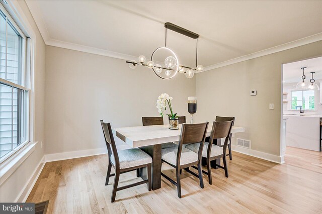 569 Riverside Dr, Princeton, NJ 08540 - dining area with ornamental molding, light wood-type flooring, and a chandelier