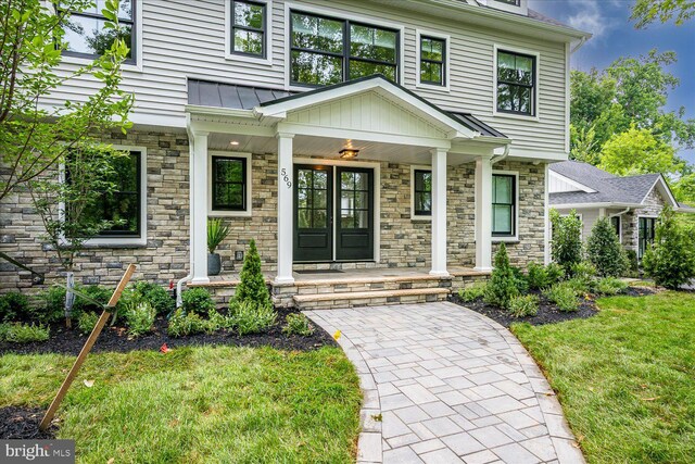 569 Riverside Dr, Princeton, NJ 08540 - doorway to property featuring a porch, stone siding, a yard, and a standing seam roof