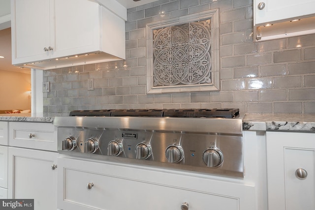 431 Waynesbrooke Rd, Berwyn, PA 19312 - kitchen view of tasteful backsplash, white cabinets, and stainless steel gas stovetop