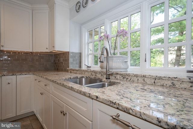 431 Waynesbrooke Rd, Berwyn, PA 19312 - kitchen with decorative backsplash, white cabinets, and light stone counters