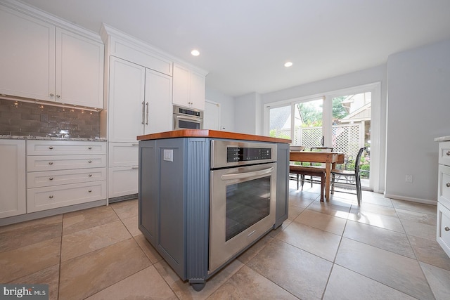431 Waynesbrooke Rd, Berwyn, PA 19312 - kitchen with stainless steel oven, tasteful backsplash, white cabinetry, recessed lighting, and wood counters